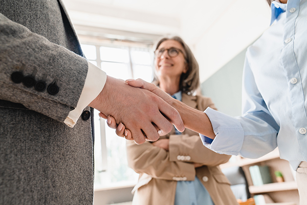 Happy young business man bank manager handshaking client at meeting. Smiling male hr hiring recruit at job interview, insurance agent, lawyer making contract deal at work with business handshake.